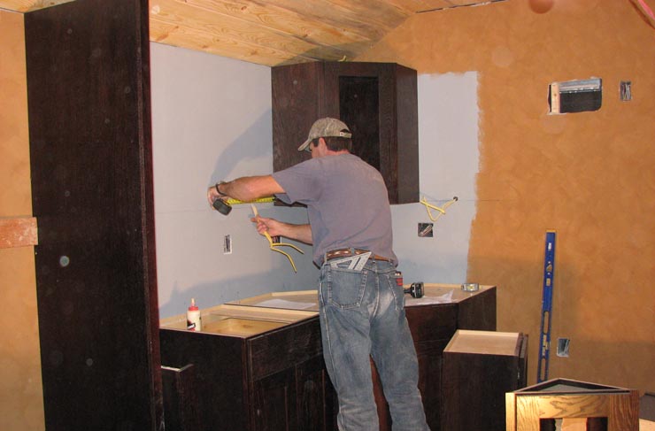 Installing cabinets in GN 441's kitchen